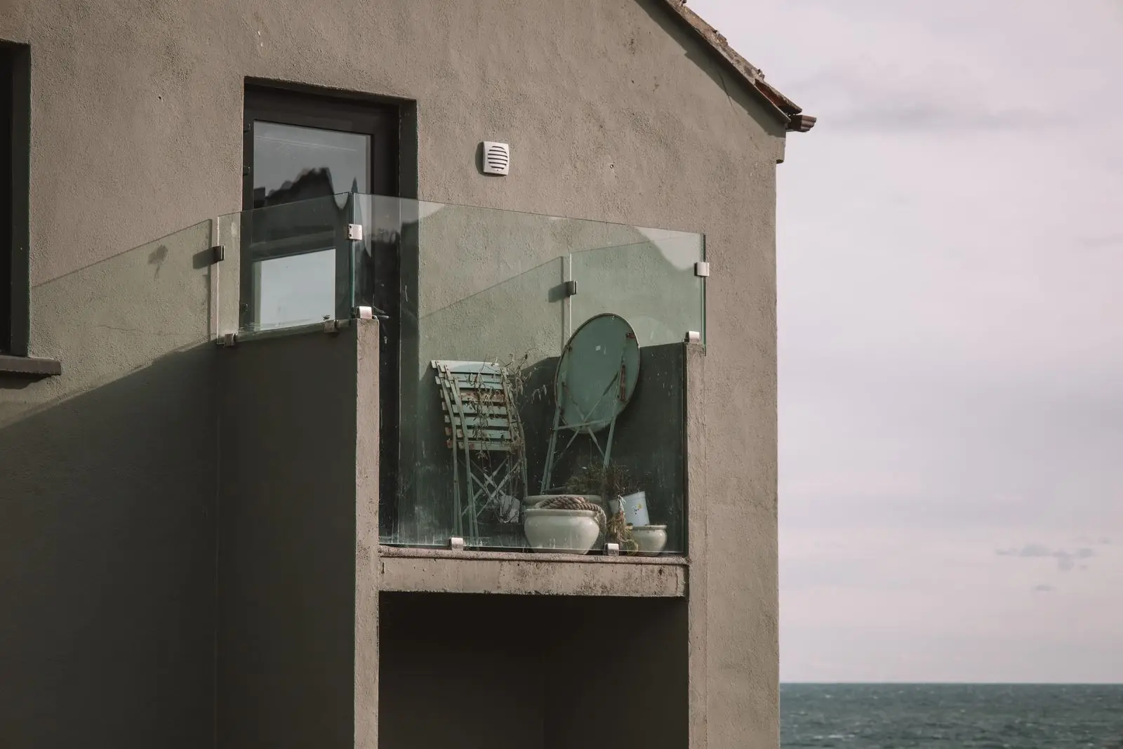 Balcony with glass railing by the sea